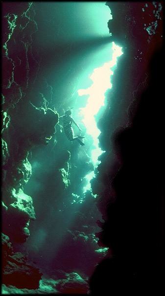 Freddy, deep in a coral cavern off the island of Ouvea in the Loyalty Island group of New Caledonia. Click to join us in the caverns of Sea's Remembering.